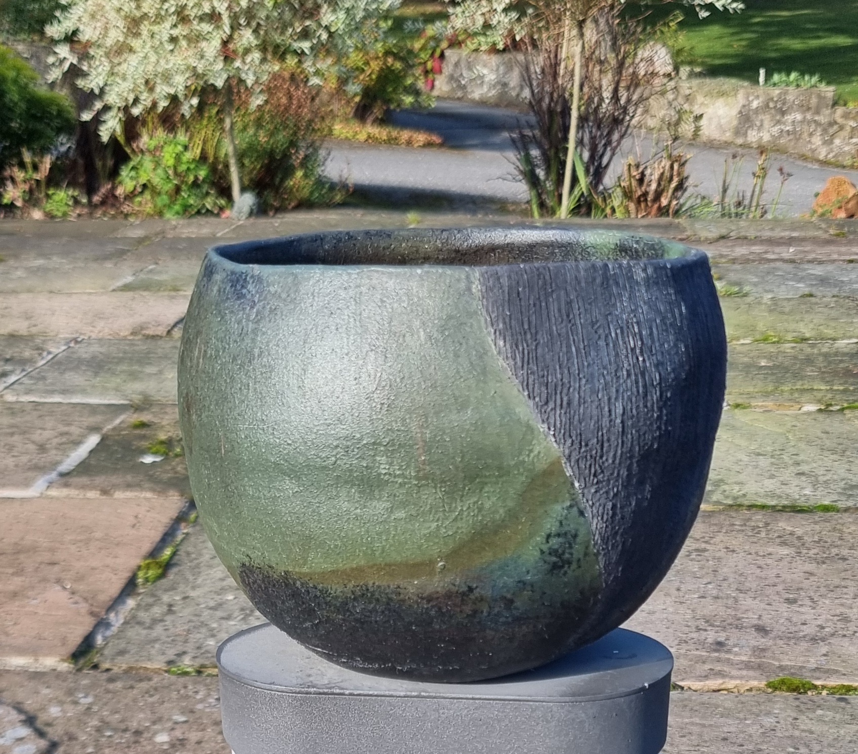 Dark glazed bowl on patio