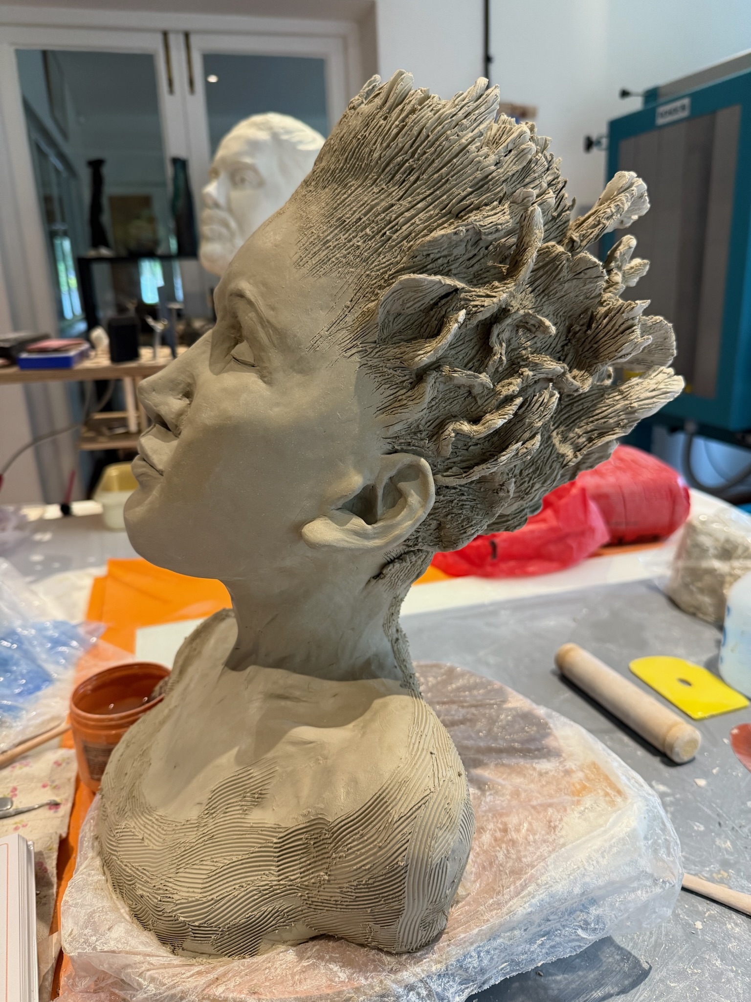 Figurative head sculpture — upturned, expressive