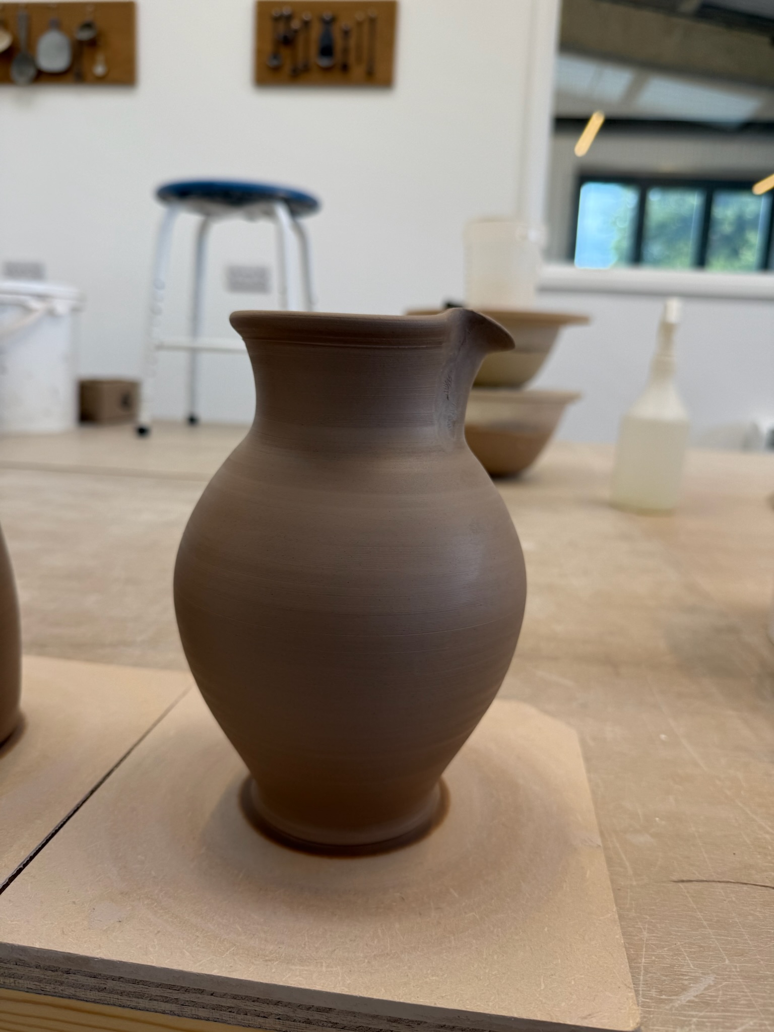 Wheel-thrown jug in studio