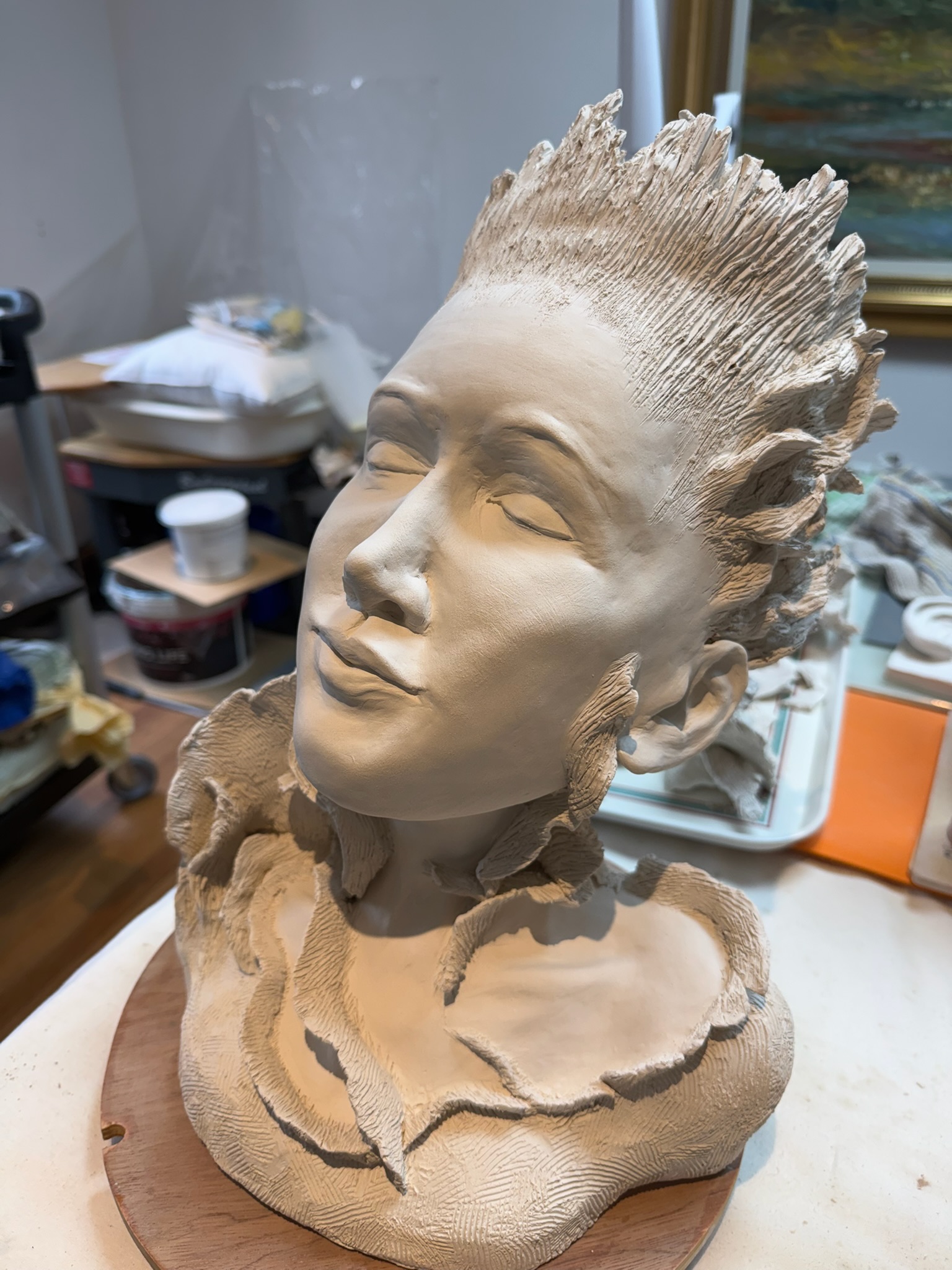 Figurative female head, serene expression, dramatic hair