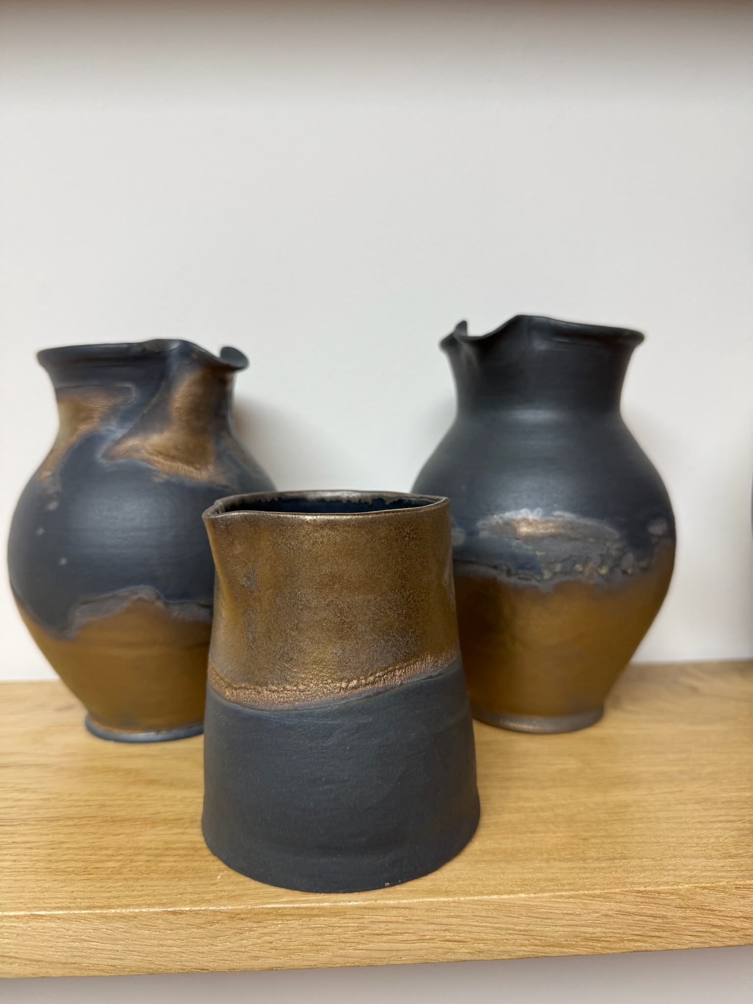 Three Raku-fired vessels in black and copper