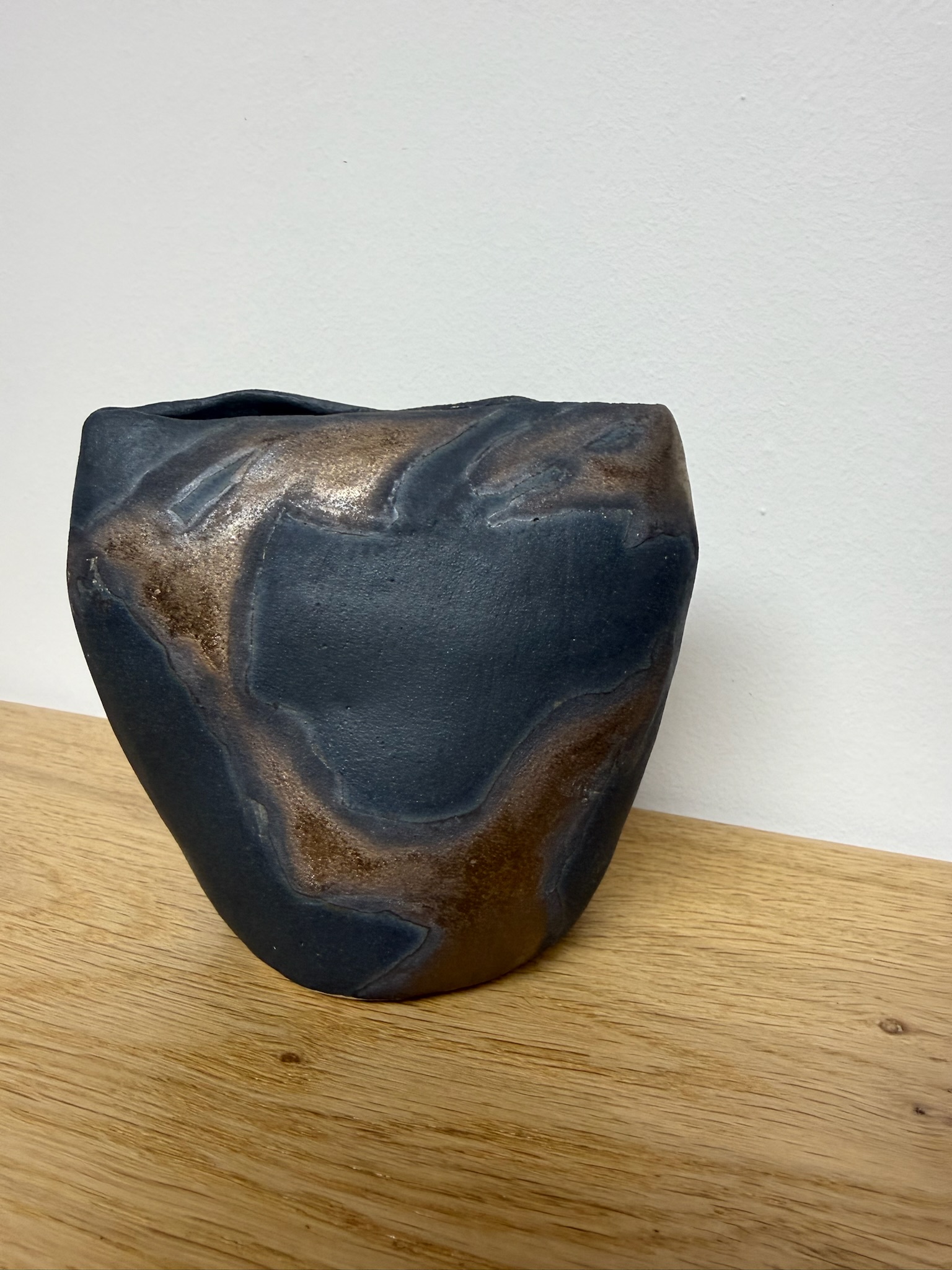 Raku fired dark copper vessel