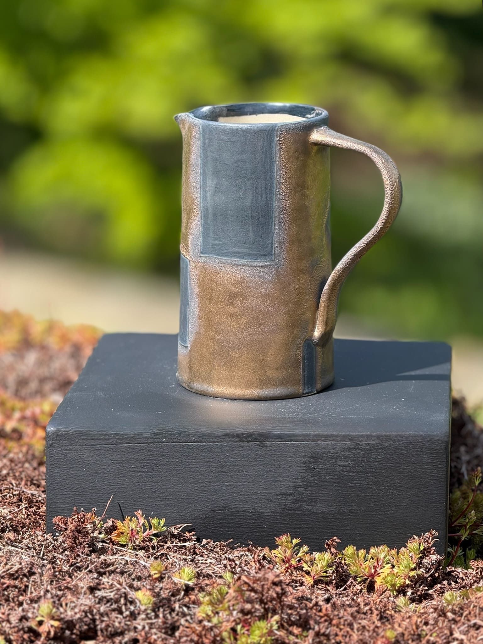 Bronze and black jug with handle