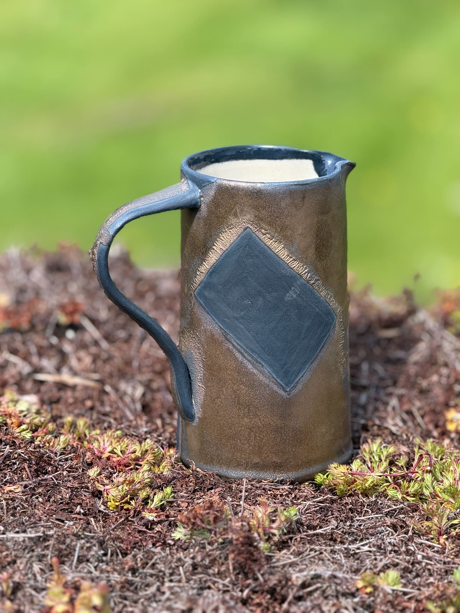 Bronze and black jug with handle, pair