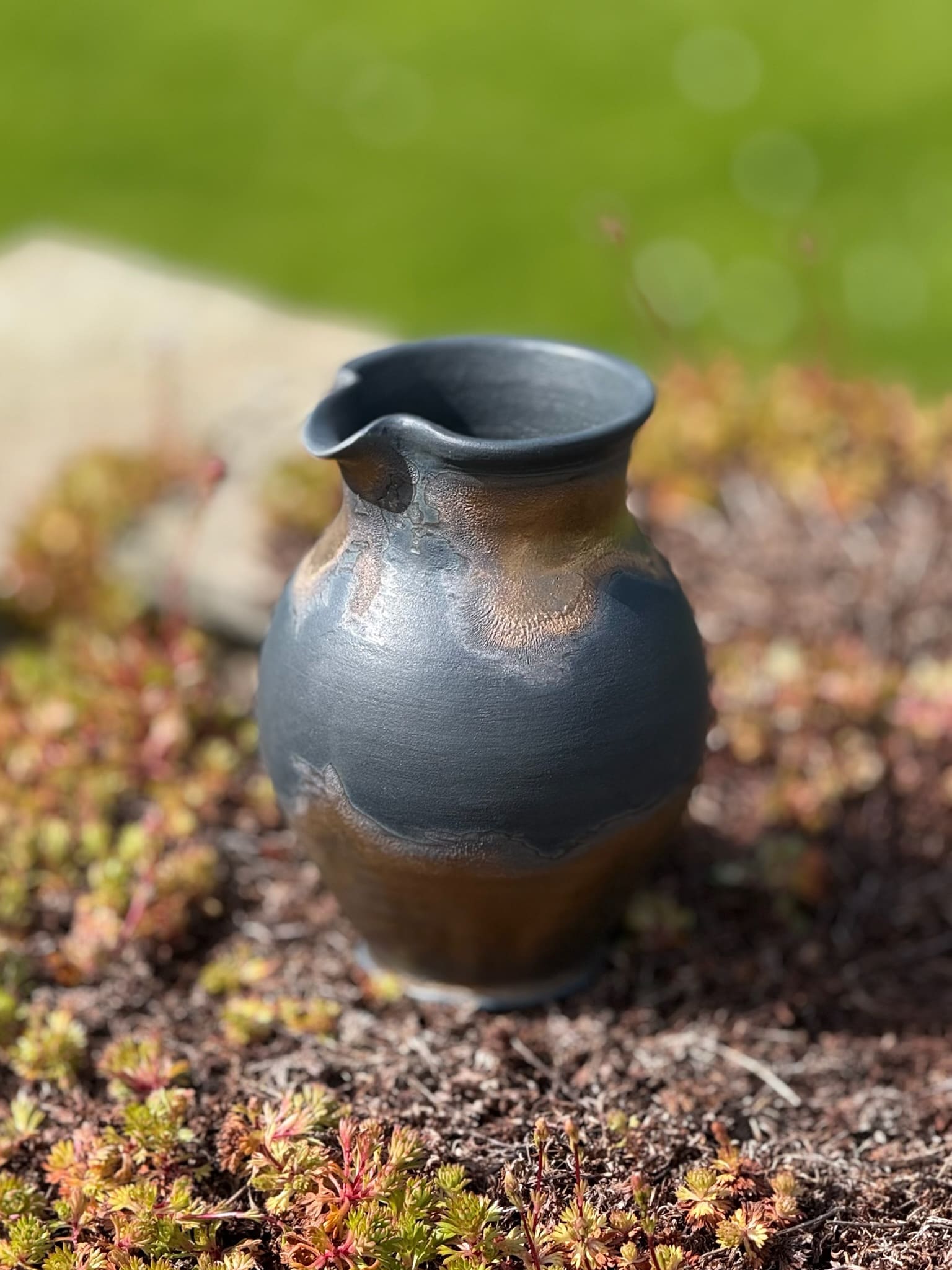 Bronze and black handleless ornamental jug