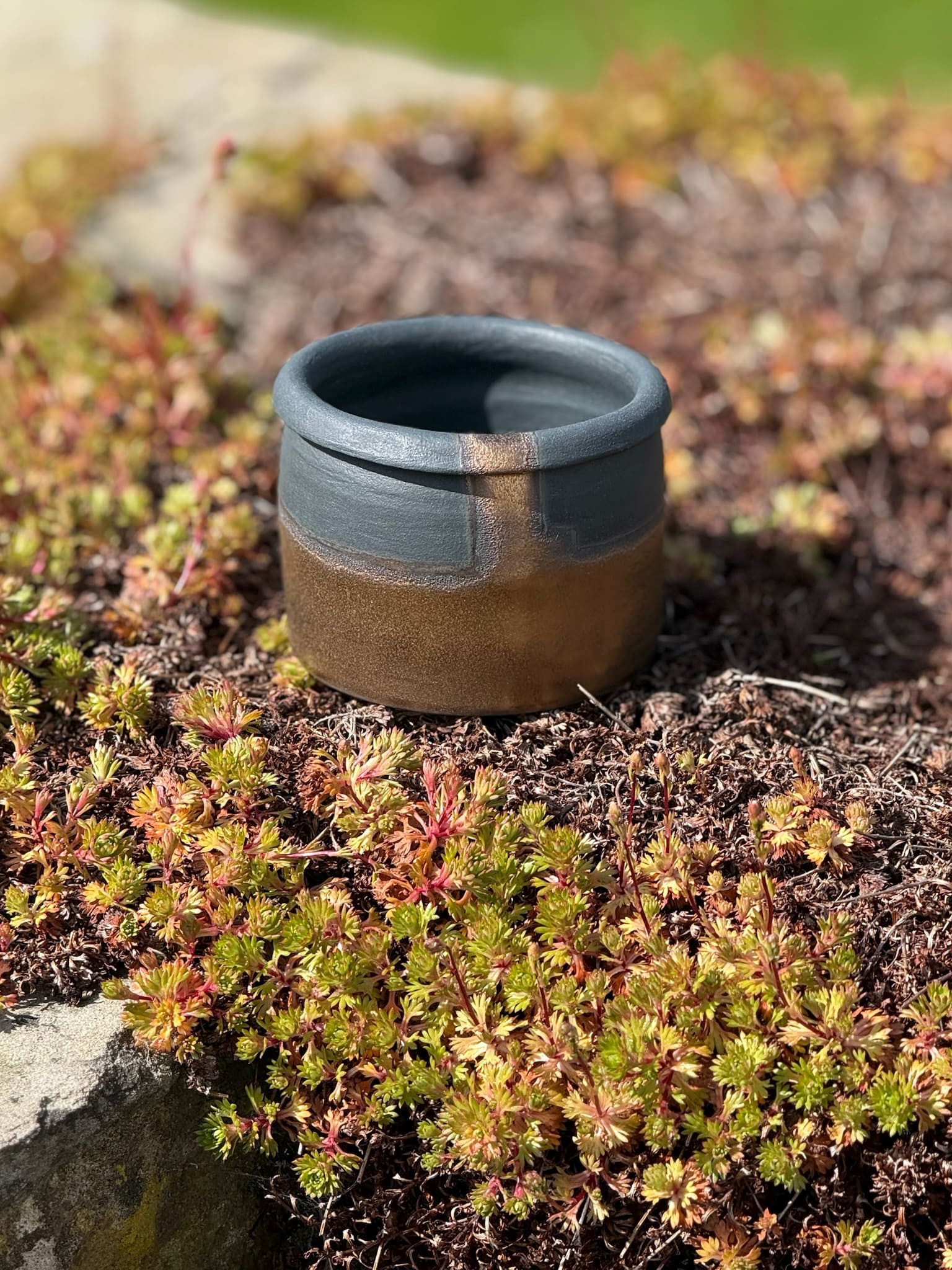Bronze and black small container with lip rim