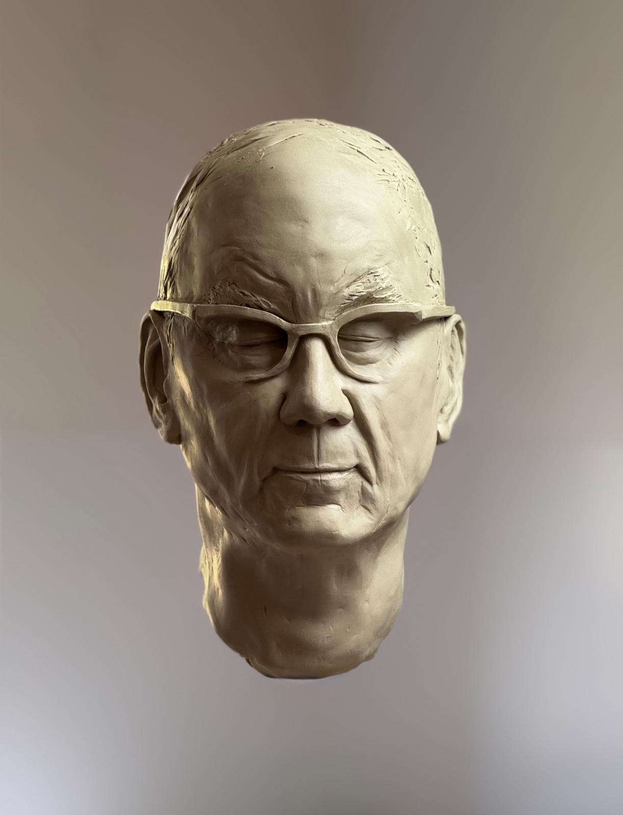 Clay portrait head of a man wearing spectacles, three-quarter view