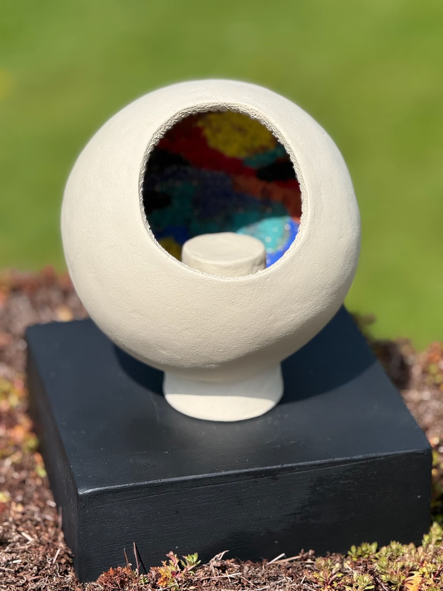 Footed ceramic bowl with raised multicoloured floral relief
