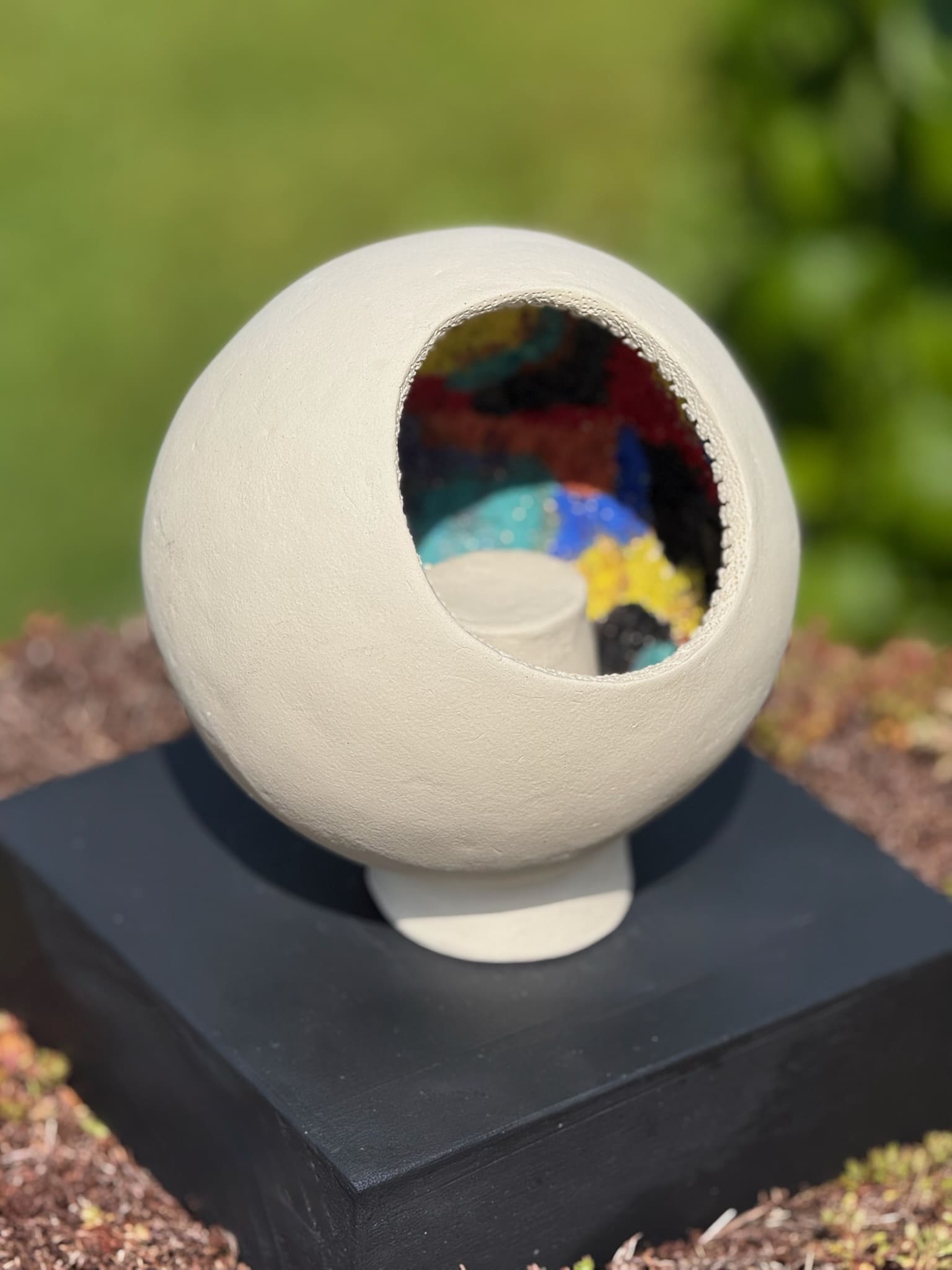 Footed ceramic bowl with vivid colour relief detail inside