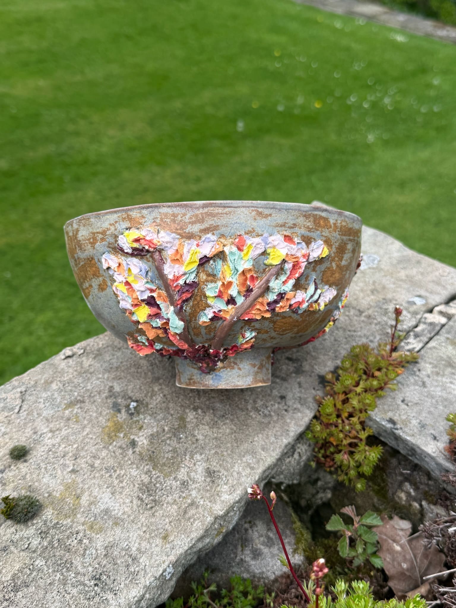 White ceramic sphere on plinth with a vivid colour seam down one side