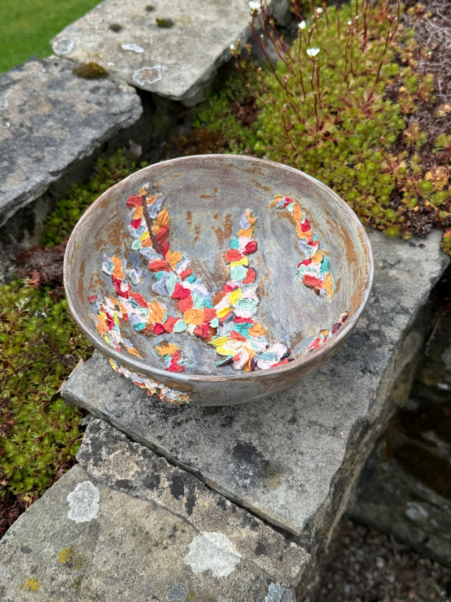 Glazed ceramic bowl with bright multicoloured speckled relief inside